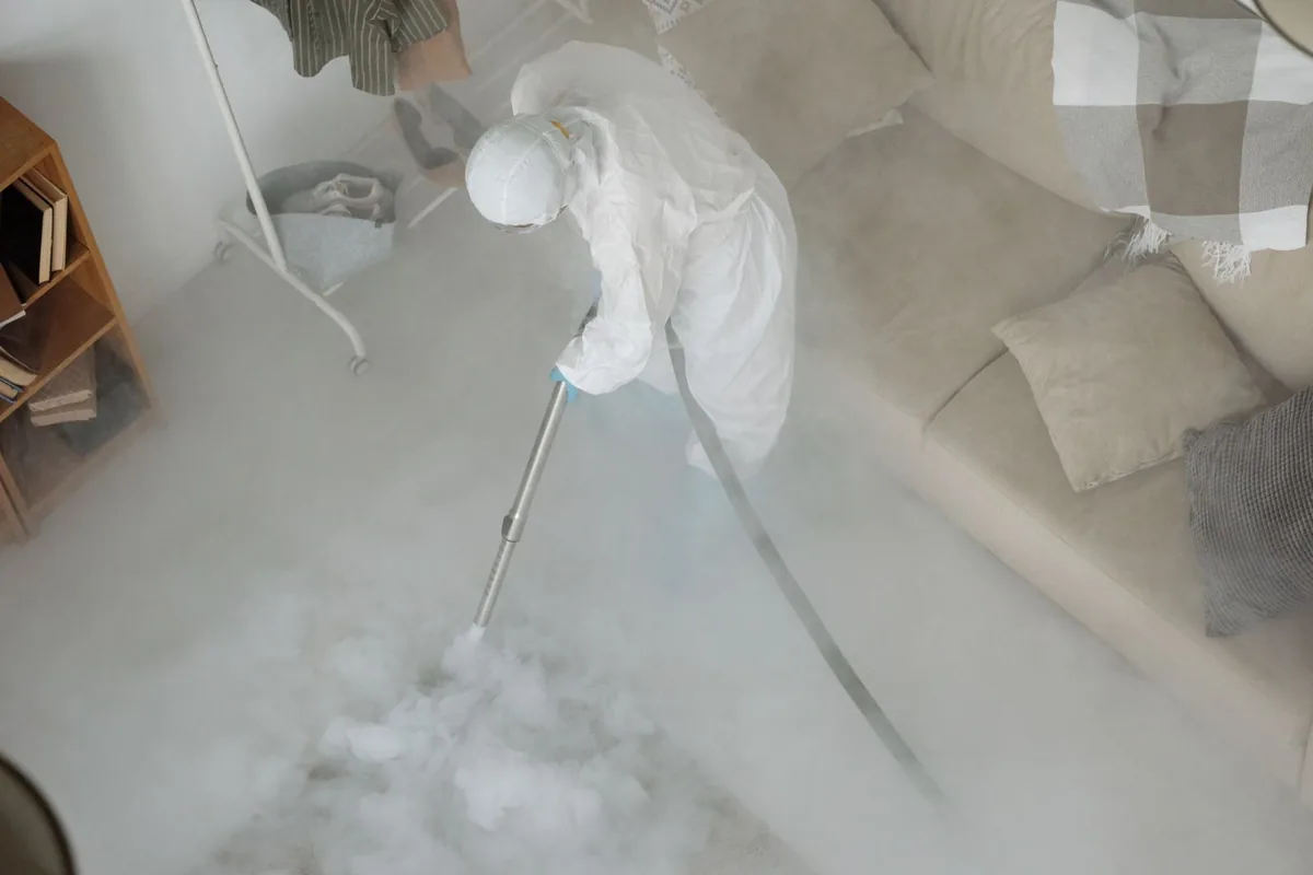 Biohazard cleanup technician in protective equipment, Scanlon, MN
